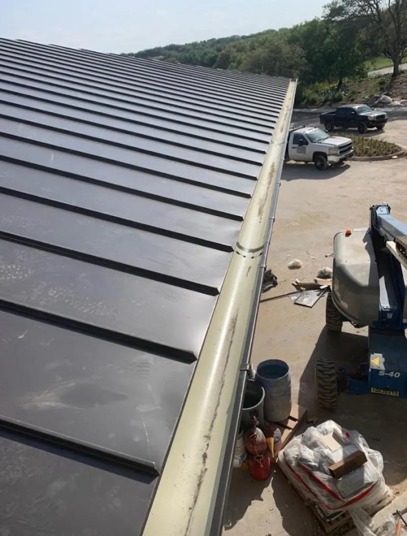 Standing seam panel and gutter detail on a metal roofing jobsite in San Fernando